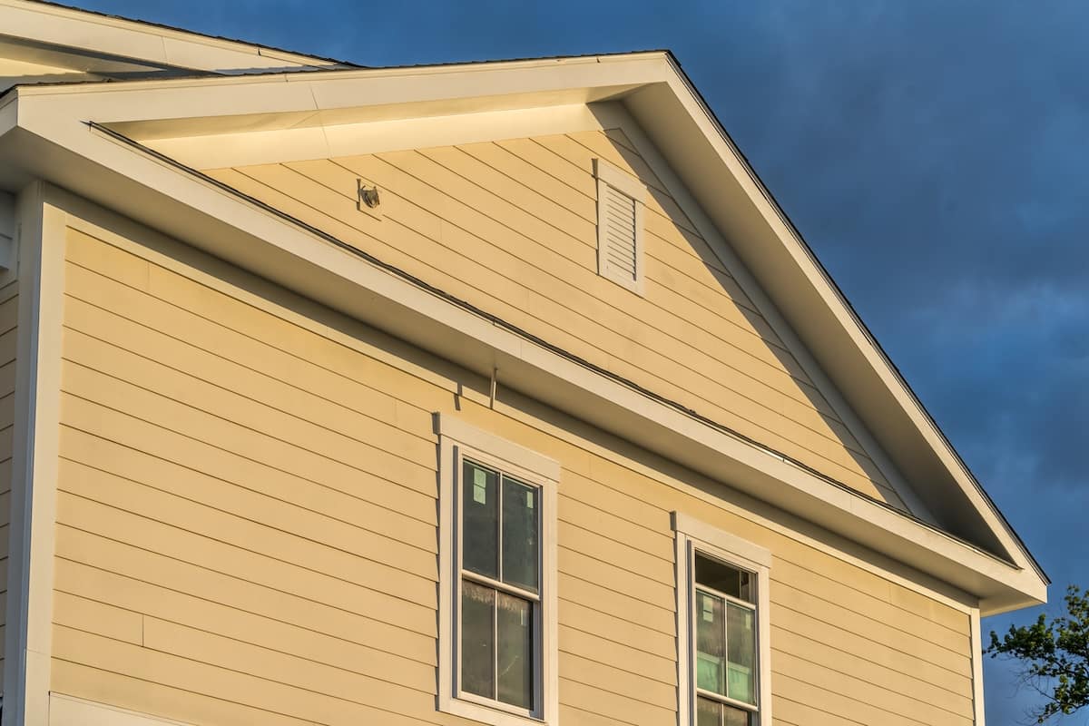 Tan yellow house with white frieze