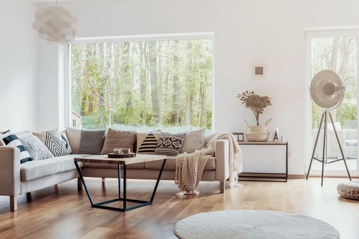scandinavian style living room with large white windows