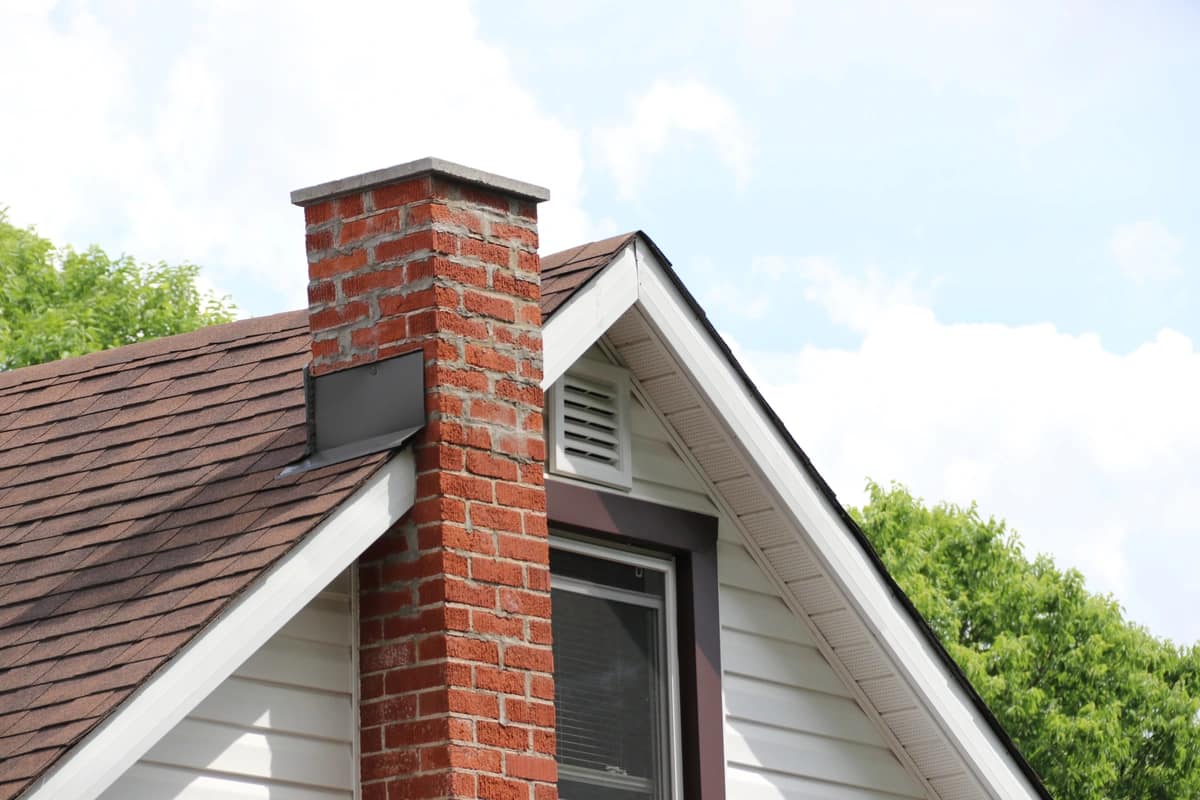 chimney repair-brick chimney on the side of a home