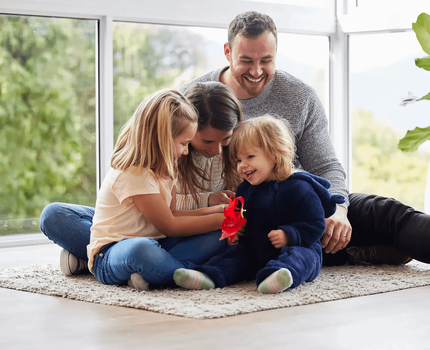 Family happily plays in home after getting quality roof repair services