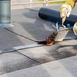contractor performing commercial roof maintenance