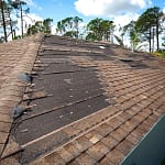 closeup of hurricane roof damage in need of repair