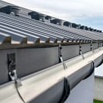 closeup of metal roof with new gutter installation