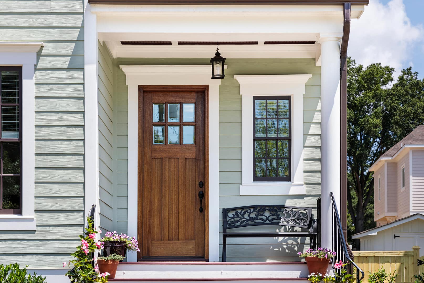 door installation jeffersontown ky-light green sided house with brown wooden front door