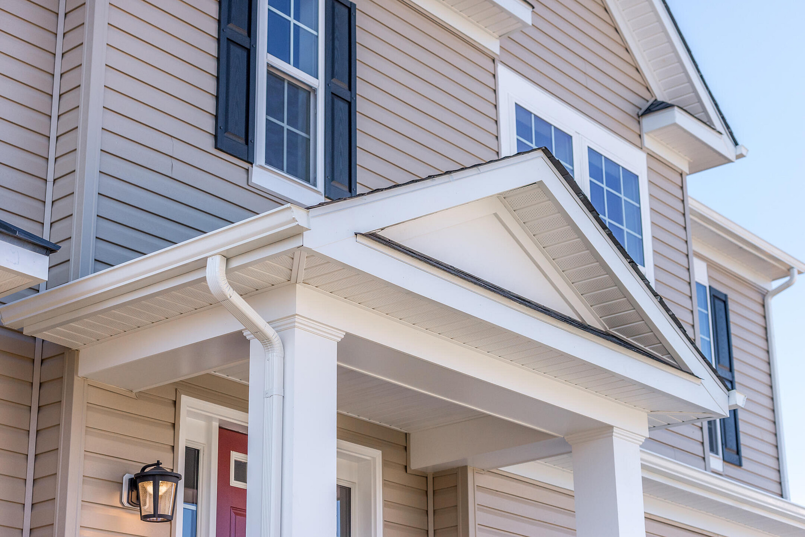 types of siding-beige vinyl siding on a house