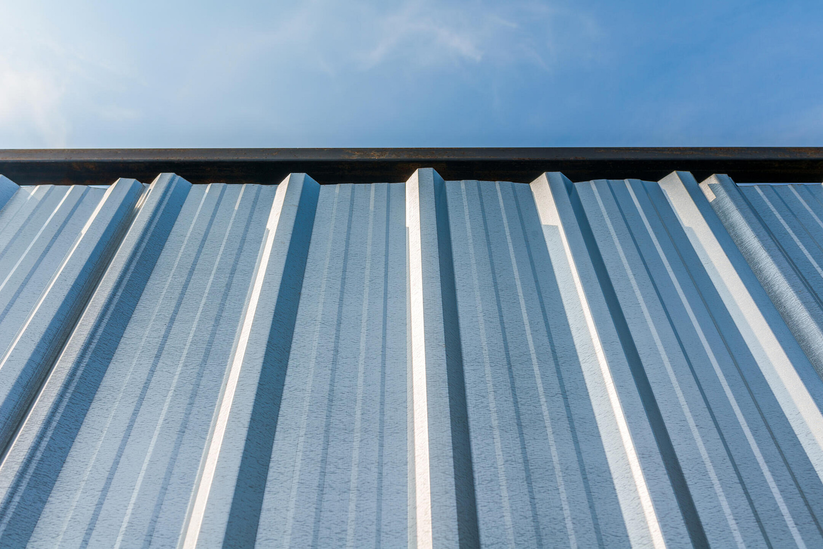 how much does a steel roof cost-close up of steel metal roofing on a pitched roof