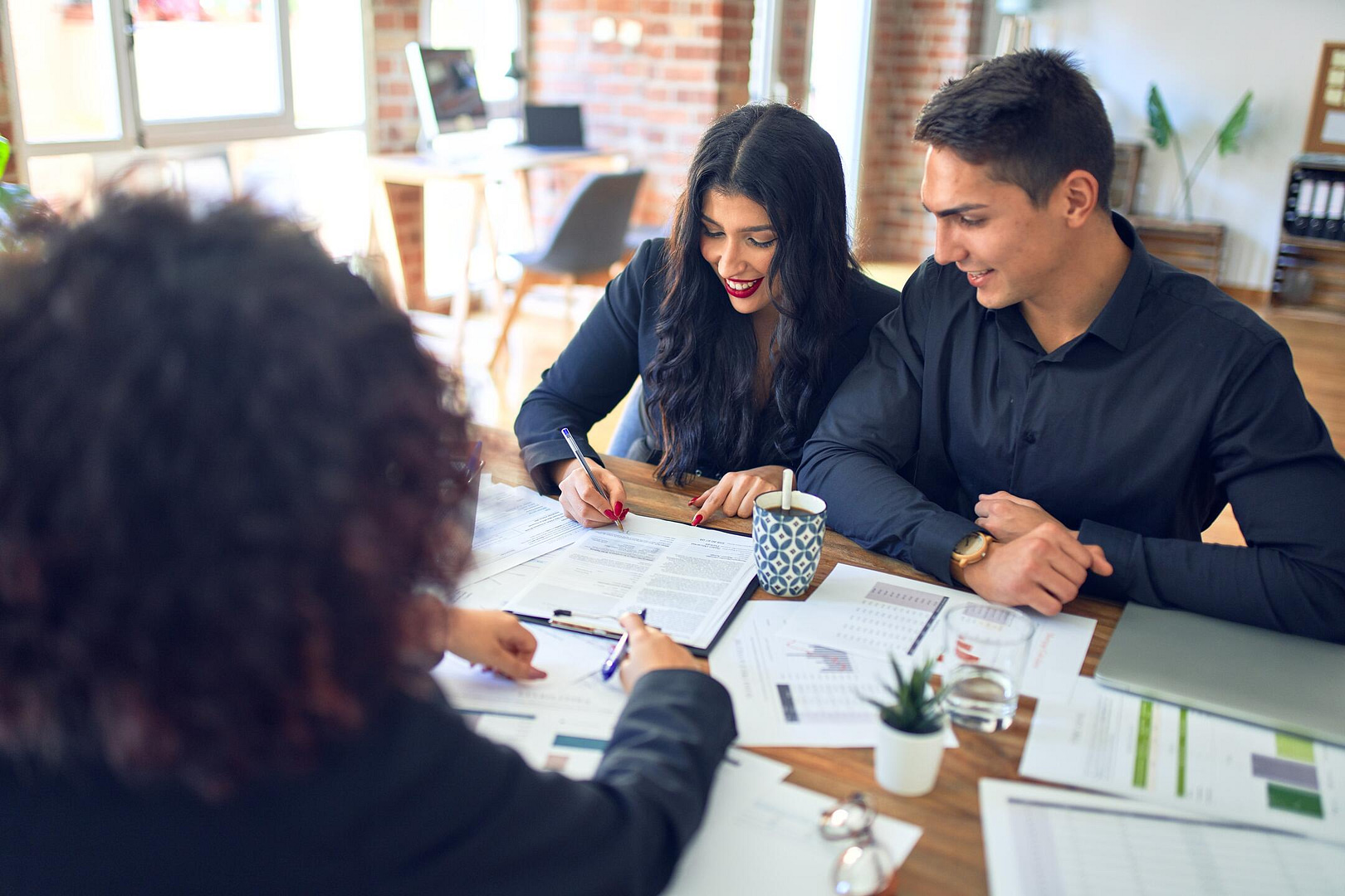 roof financing-couple working with a banker to secure roof financing