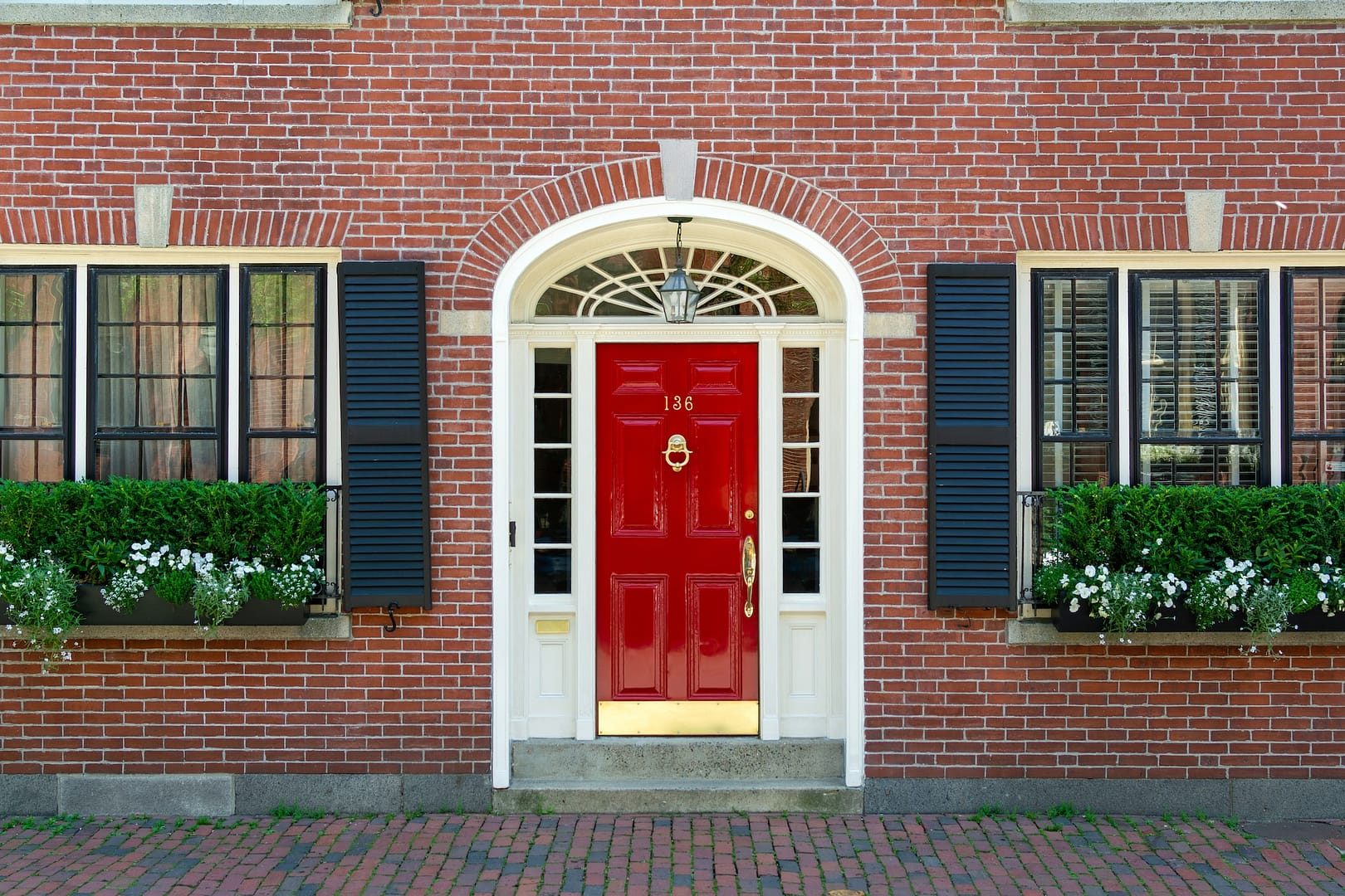 Beautiful red door on charming brick house