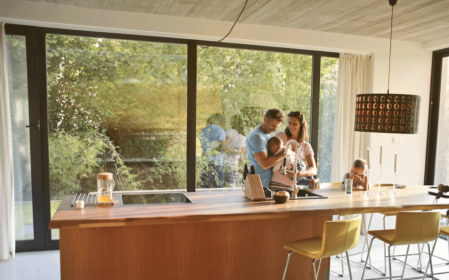 Happy family in kitchen with large windows