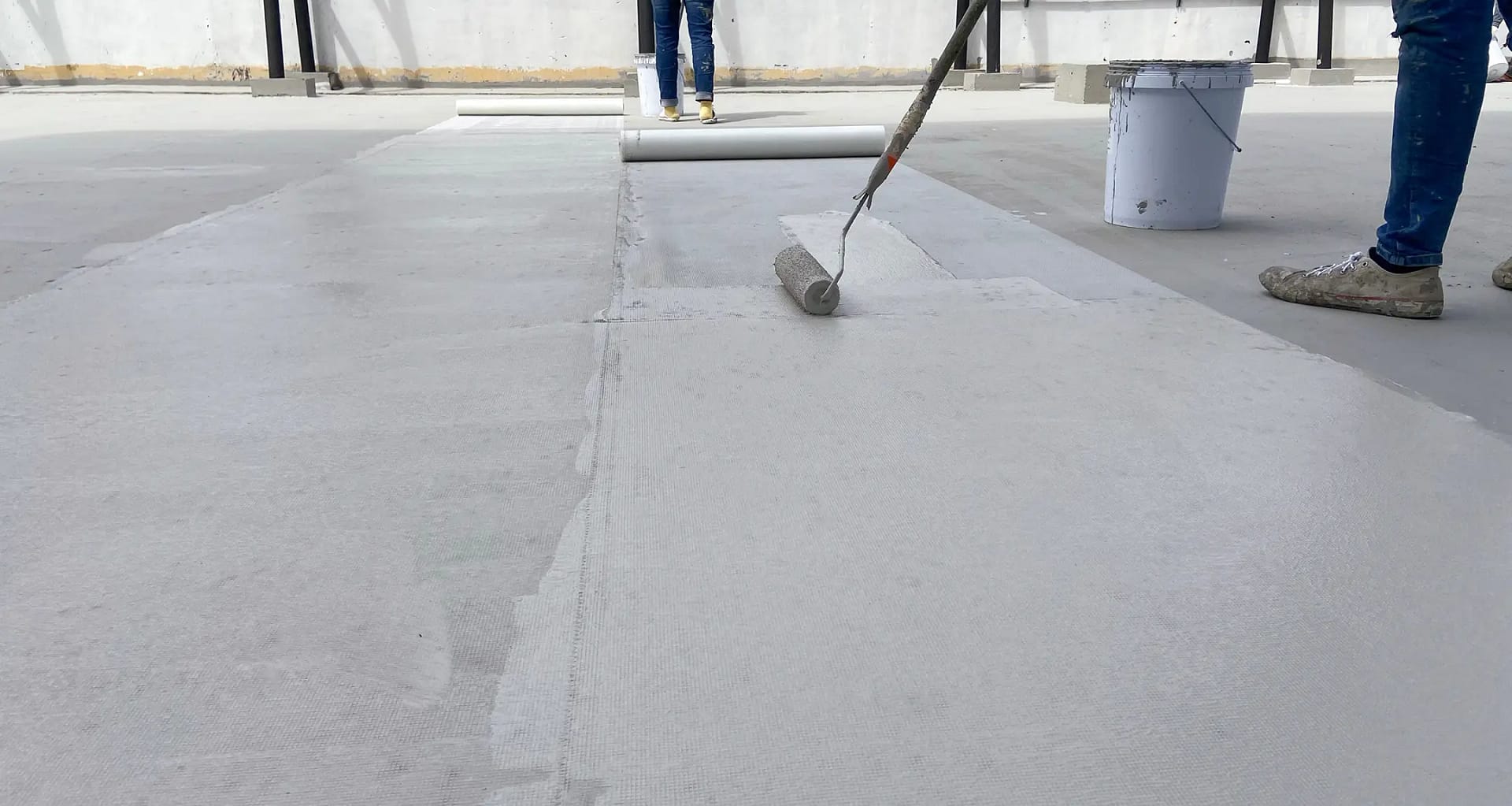 contractor covers flat roof with coating