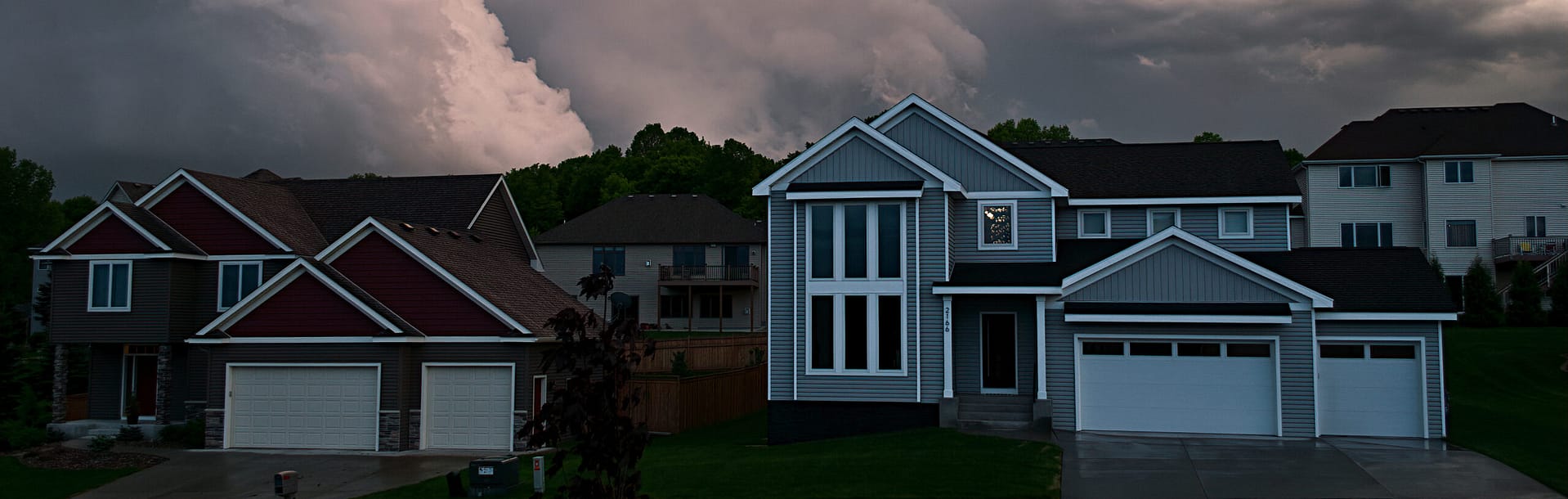storm brewing over minnesota neighborhood roofscape