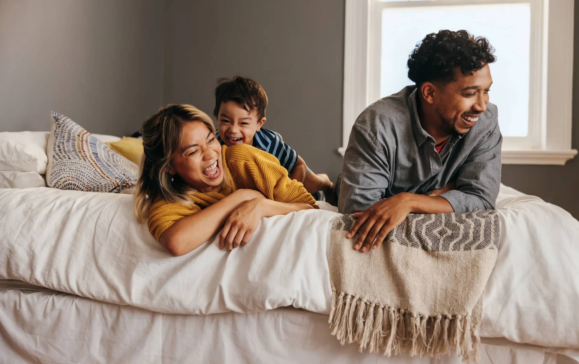Happy young family in new home with freshly installed roof.