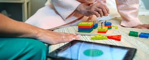 Female doctor showing geometric shapes to elderly patient activities for memory care patients ideas and uses