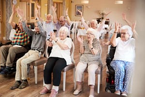 Group Of Seniors Enjoying Fitness Class In Retirement Home Group Of Seniors Enjoying Fitness Class In Retirement Home