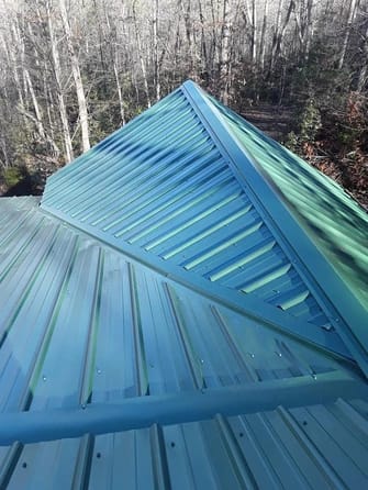 close up to green metal roof of house