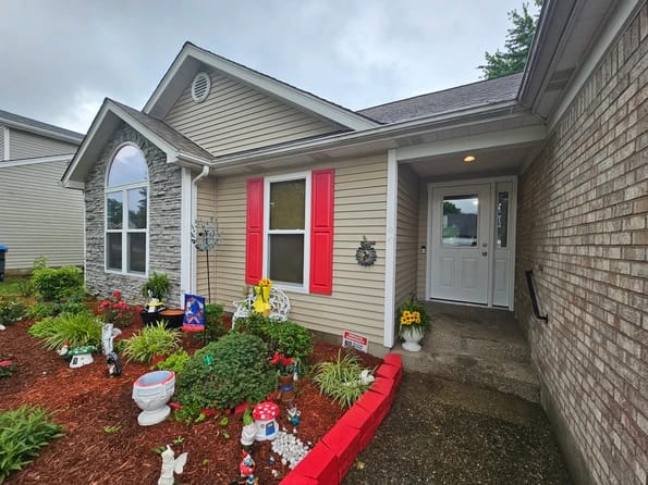 Louisville, KY home with red shutters and new windows with white frames
