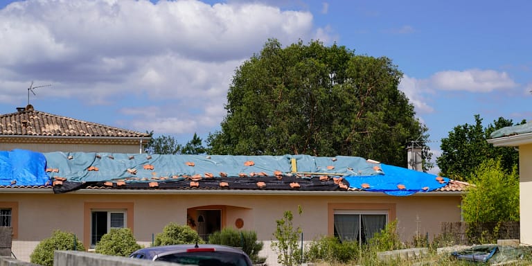 large house after hail damage on the roof