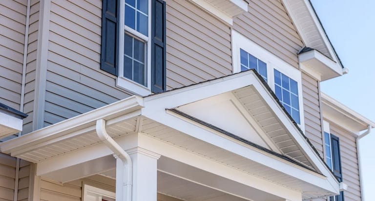 close up view of house porticos and light grey vinyl siding