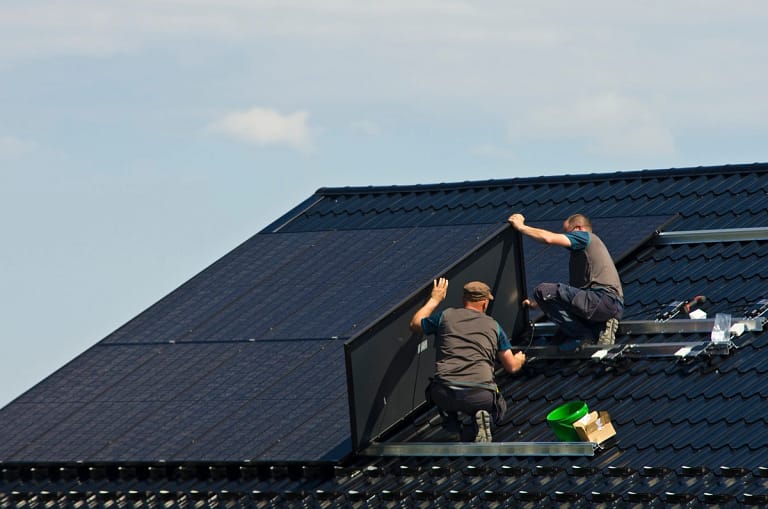 close up of licensed roofing company installing new modern solar panels
