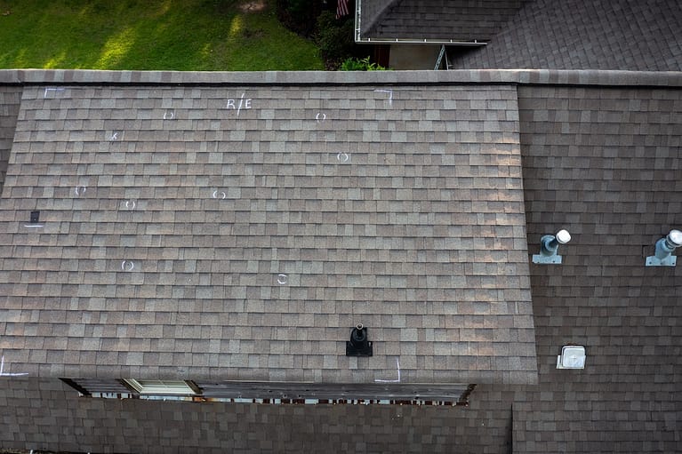 Roof with hail damage and chalk markings from inspection