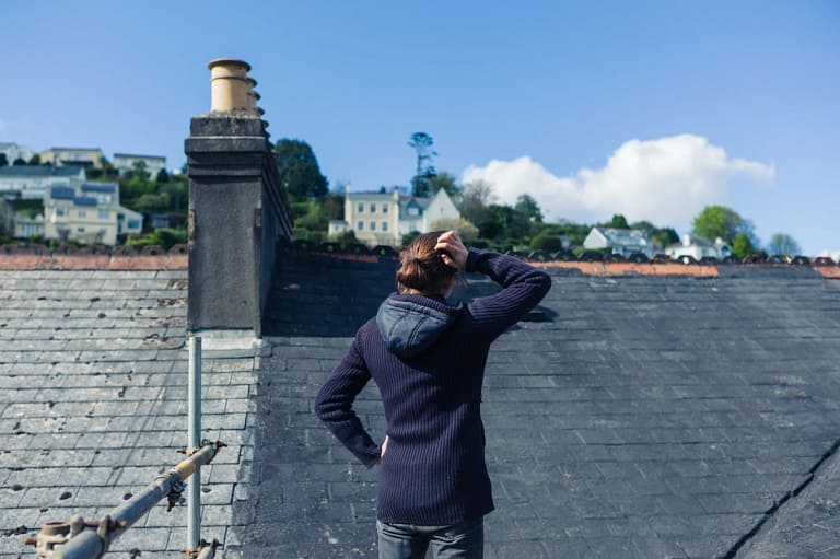 young woman worried about roof damage