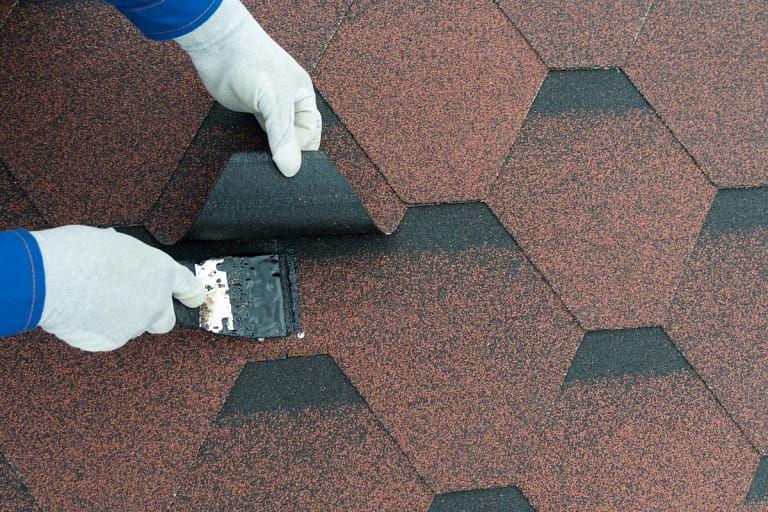 man installing new shingles:how to install roof shingles