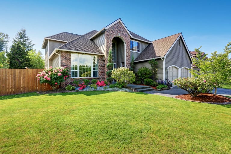A house with an asphalt shingle roof on a sunny day