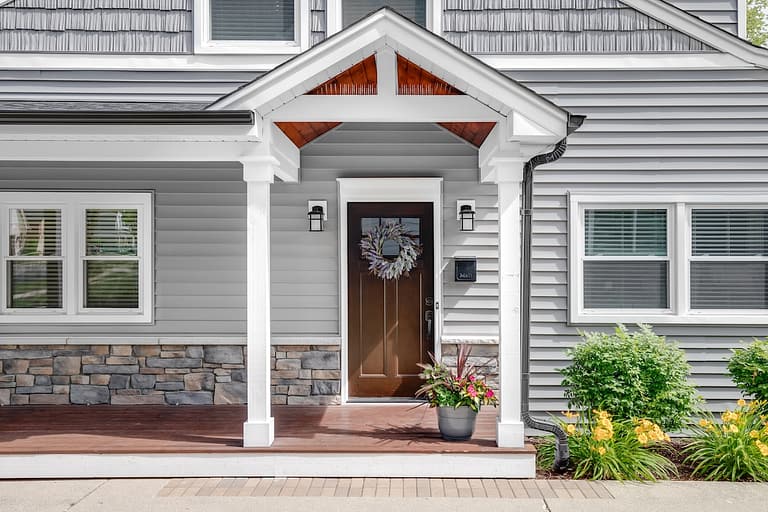 Vinyl siding on home with wood door