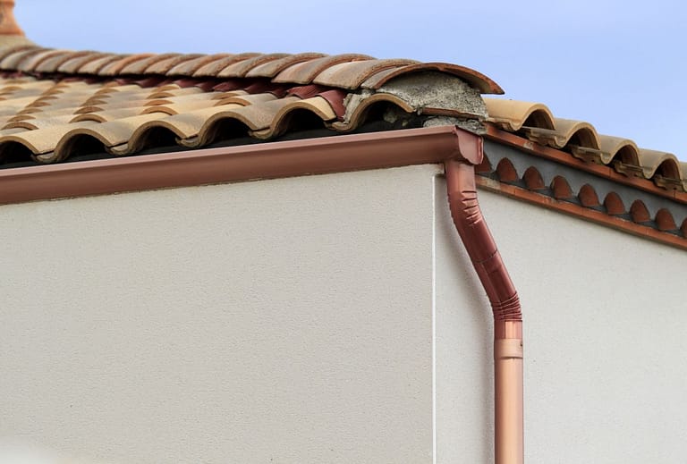 copper cutters on a house with a tile roof