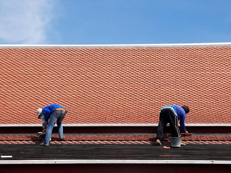 Roofers repairing roof