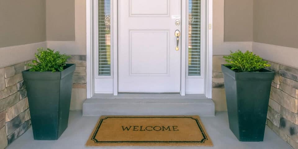 fiberglass vs steel door-close up of white front door with a welcome mat