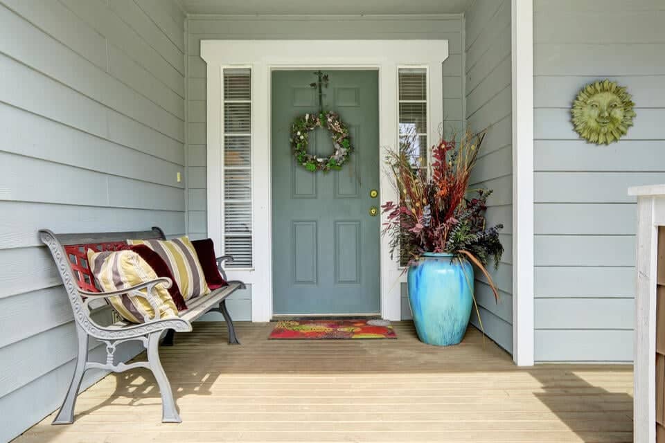 fiberglass vs steel door-dark colored front door with wreath with white trim