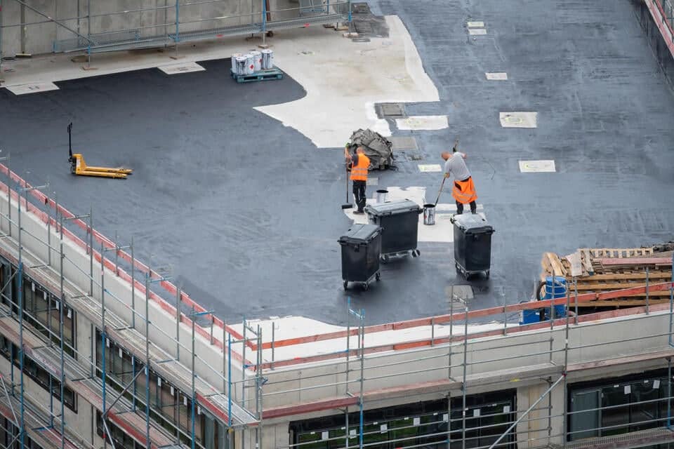 commercial roof replacement-roofing crew replacing a commercial roof on a building