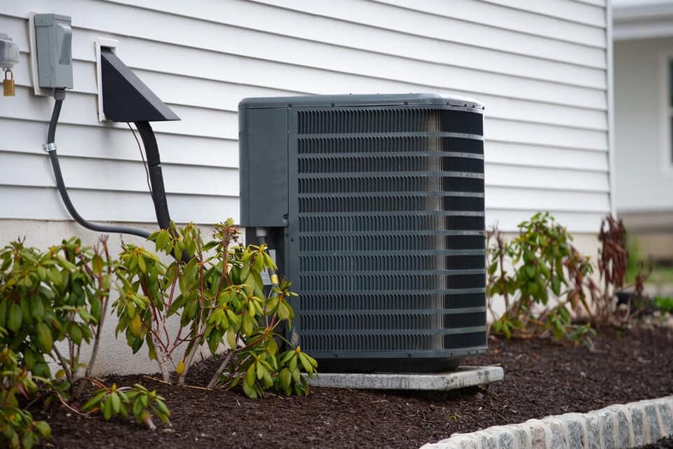 how-to-clean-ac-drain-line-outdoor-ac-unit-with-pipes-near-exterior-home-wall