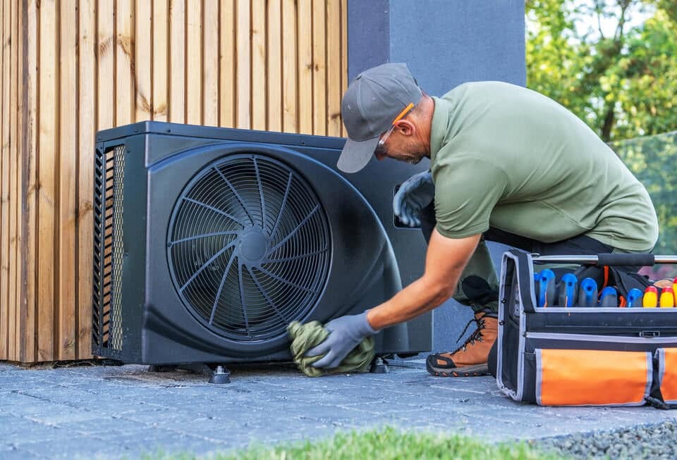 ac-installation-tech-cleaning-exterior-of-ac-unit-after-installation