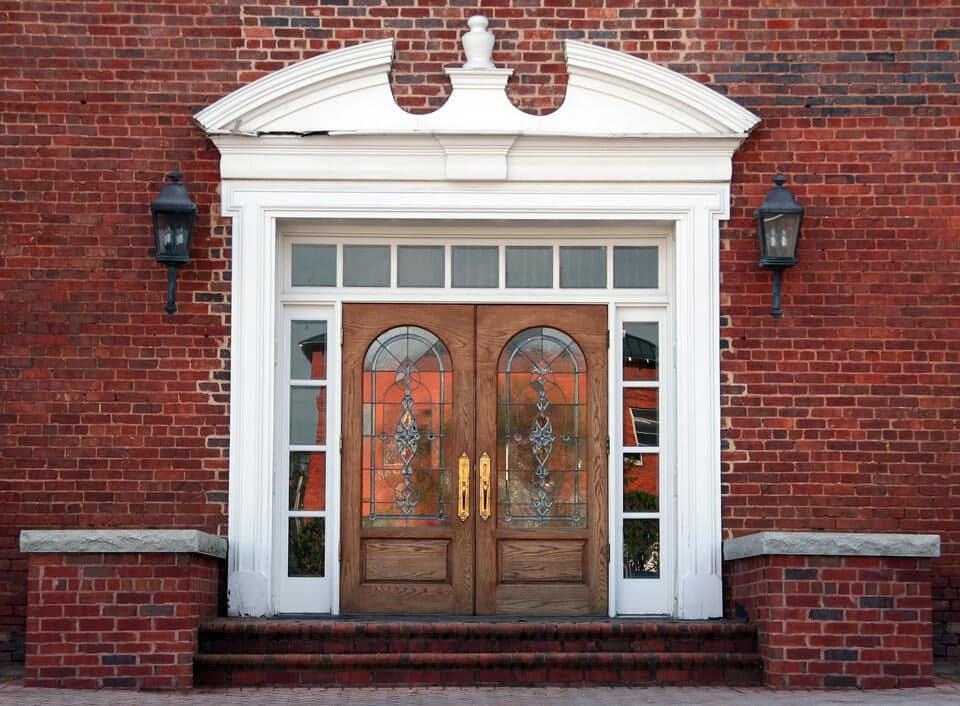 double front doors-red brick house with double front doors with large white decorative borders