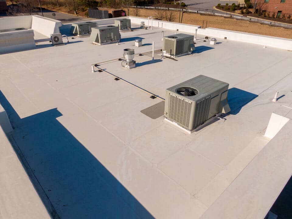 tpo roofing cost-close up of tpo roofing with hvac units on the roof
