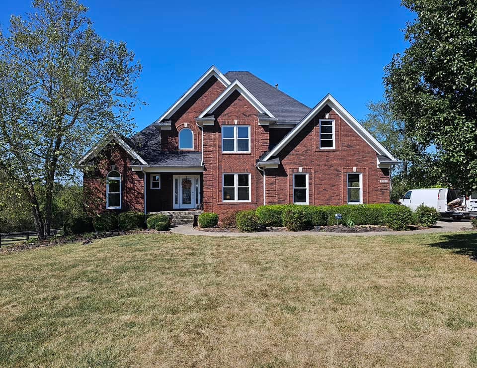 Brick home with new windows installed with white frames