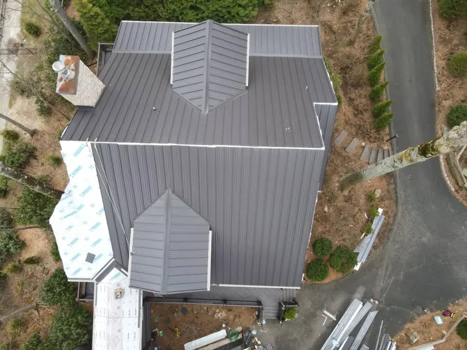 gray metal roof installation on the house