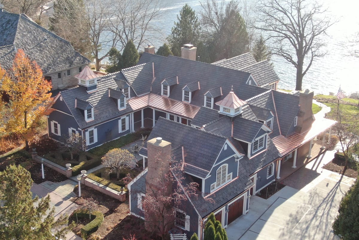 Large home with Synthetic Slate Roofing and copper roof accents