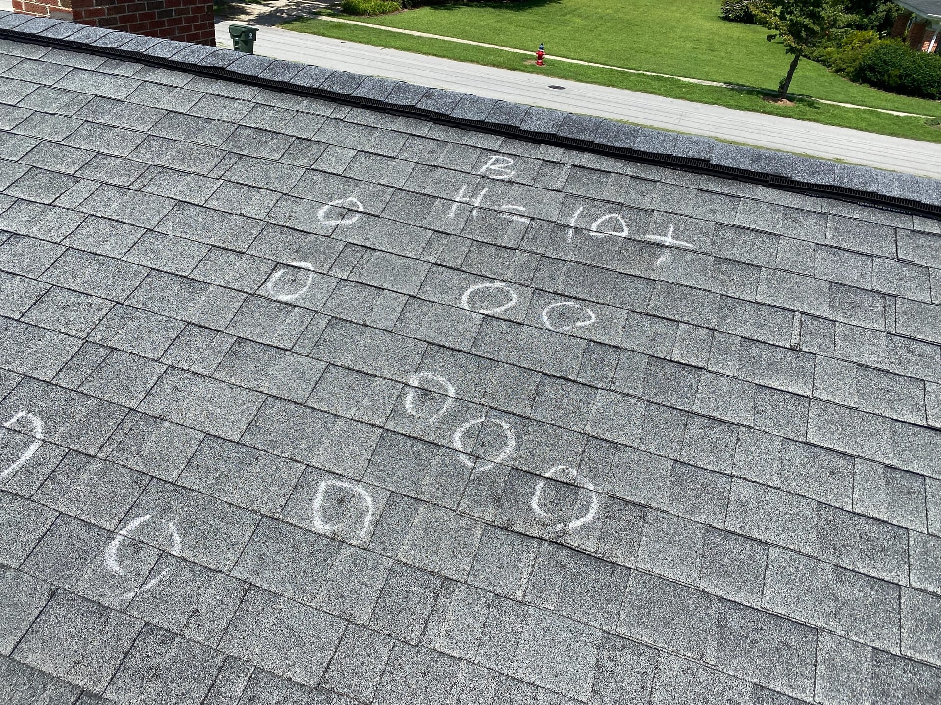 roofing shingles with hail damage marks