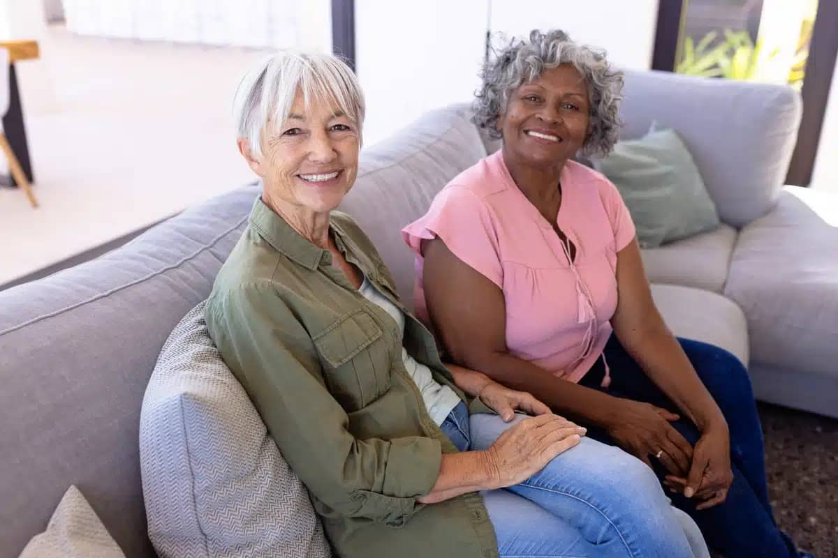 two women sitting on couch